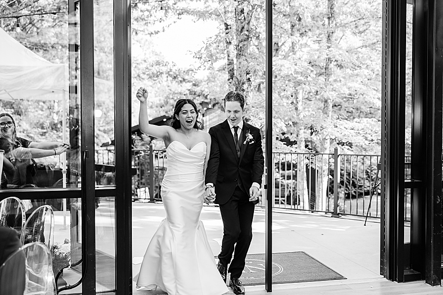 bride and groom entering reception at Glass House at Nichols Heir